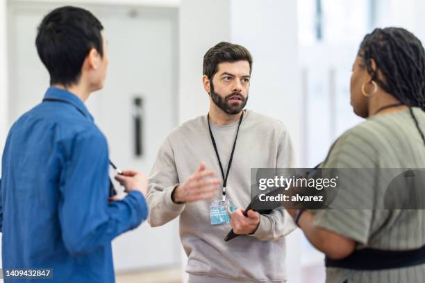 business people discussing at a conference event - business man in crowd stock pictures, royalty-free photos & images