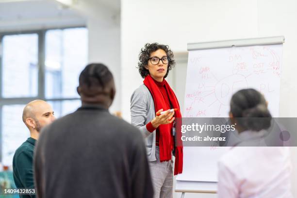 businesswoman giving presentation at the business workshop - flipchart stock pictures, royalty-free photos & images