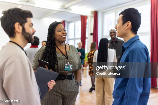 multiracial businesspeople networking at a conference - large auditorium stock pictures, royalty-free photos & images