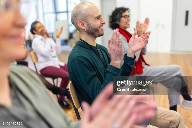 group of businesspeople clapping hands after a successful training session - participant stock pictures, royalty-free photos & images