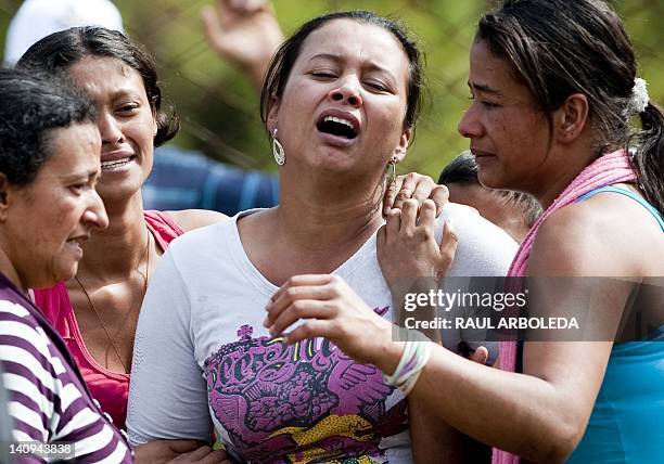 Women cry after learning that a relative died during the flood that ripped through inside a coal mine in the municipality of Angelopolis, Antioquia...