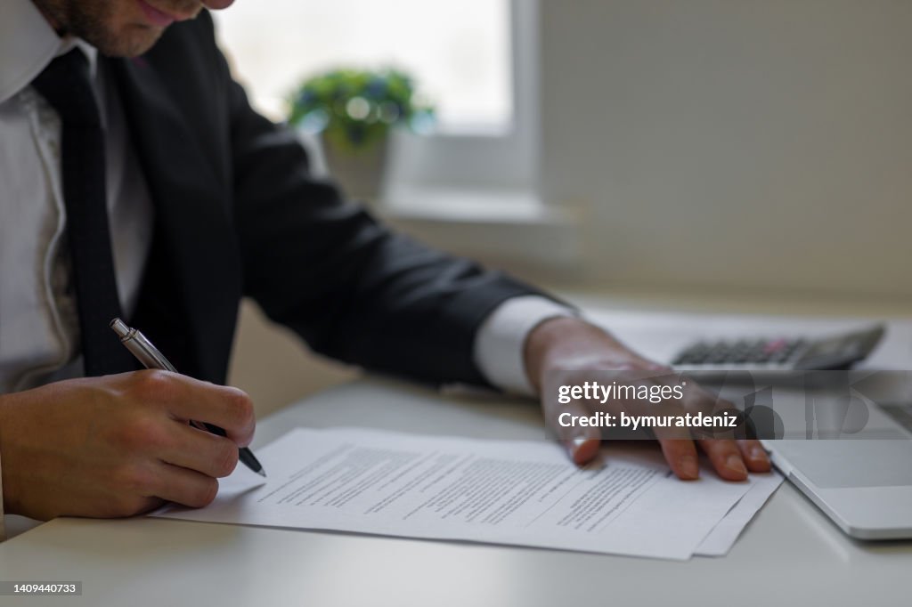 Man signing contracts