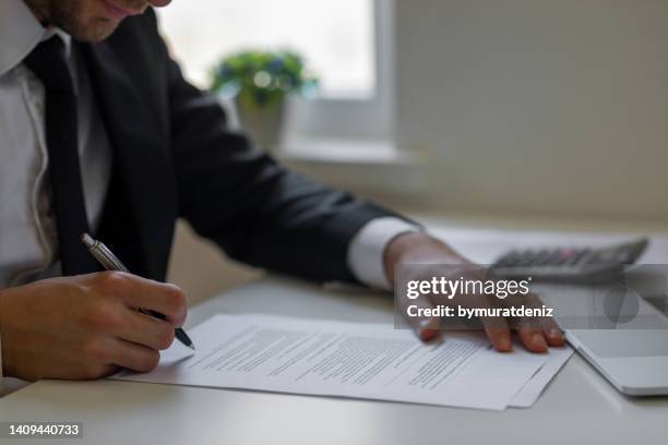 man signing contracts - message bildbanksfoton och bilder