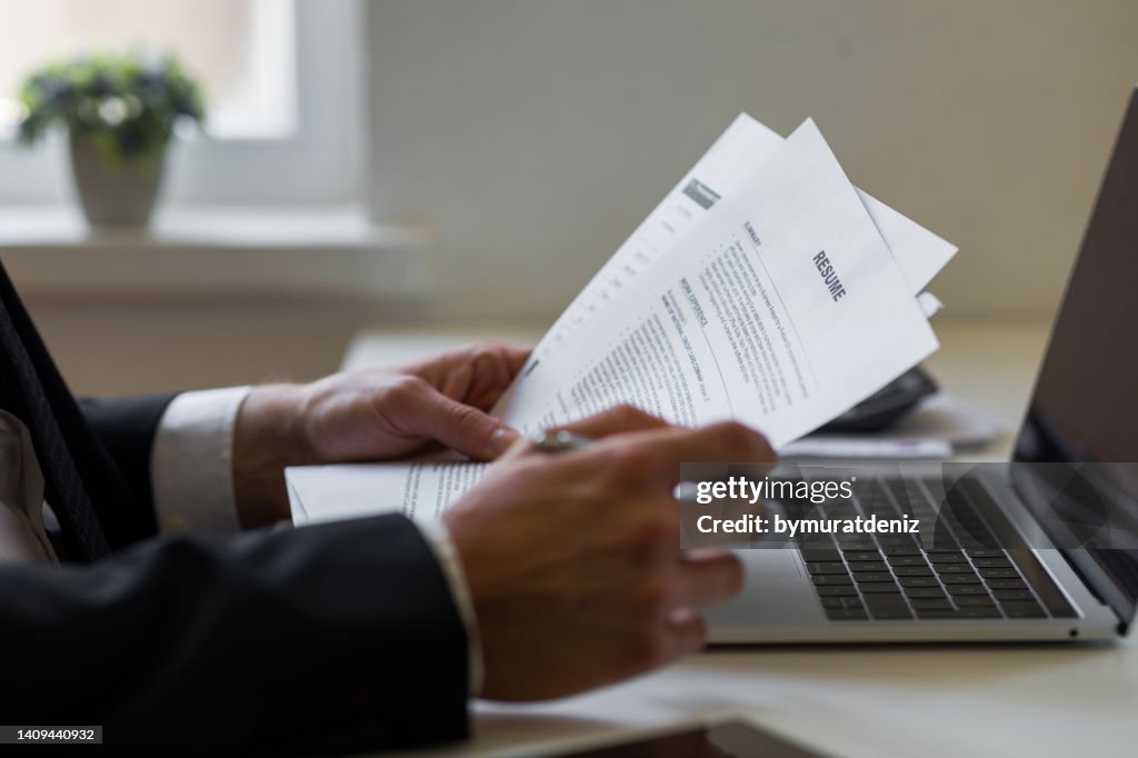 Businessman or HR Manager is reviewing Resume information