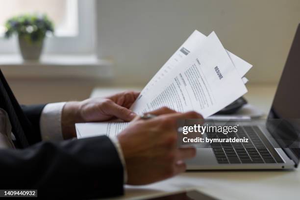 businessman or hr manager is reviewing resume information - cv bildbanksfoton och bilder