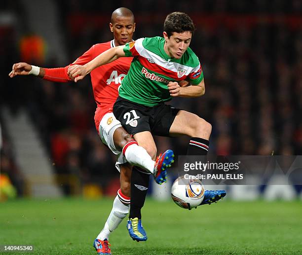 Athletic Bilbao's Spanish midfielder Ander Herrera vies with Manchester United's English forward Ashley Young during the UEFA Europa League round of...