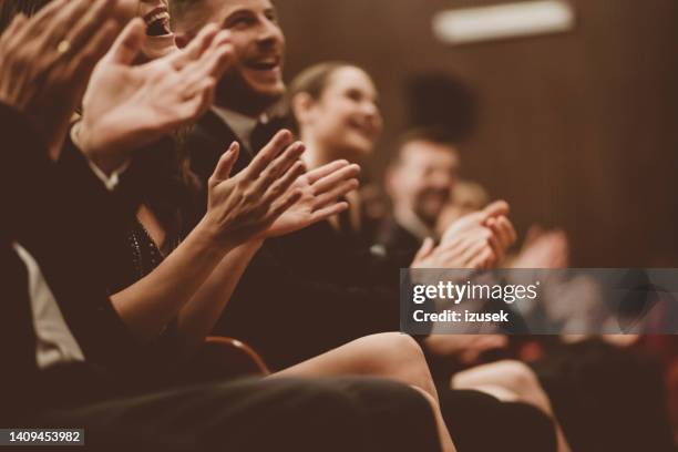 excited audience clapping in the theater, focus on hands - arts for humanity gala imagens e fotografias de stock