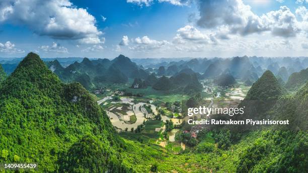 aerial drone sunrise scene with fog of road, rice field and strange shape high mountain in cao bang province, north of vietnam, border of china - asia village river stock pictures, royalty-free photos & images