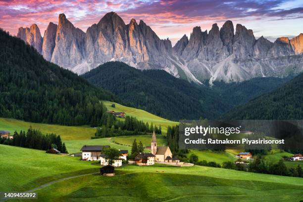 beautiful view of idyllic mountain scenery in the dolomites with famous santa maddelana mountain village in beautiful golden evening light at sunset in fall, val di funes, south tyrol, northern italy. - trentino stock pictures, royalty-free photos & images