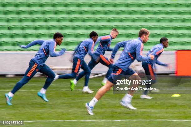 Anthony Martial and Will Fish of Manchester United in action during a Manchester United pre-season training session at AAMI Park on July 18, 2022 in...