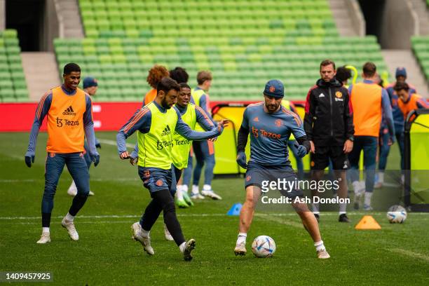 Bruno Fernandes and Luke Shaw of Manchester United in action during a Manchester United pre-season training session at AAMI Park on July 18, 2022 in...