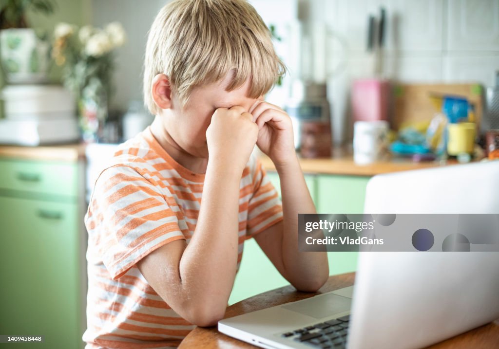 Myopic boy squinting