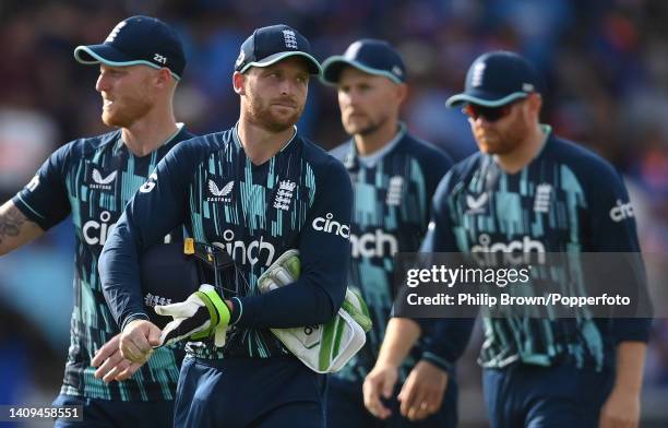 Jos Buttler of England leaves the field with Ben Stokes , Joe Root and Jonny Bairstow after India won the third ODI between England and India at...