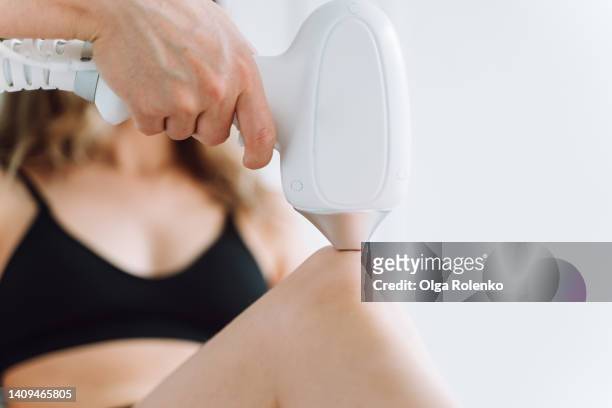 cropped woman body in underwear lying on a white couch get laser hair removal procedure for legs - hairy body 個照片及圖片檔