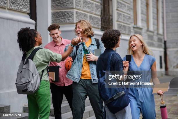 group of happy teenagers together in front of school. - school holiday stock-fotos und bilder