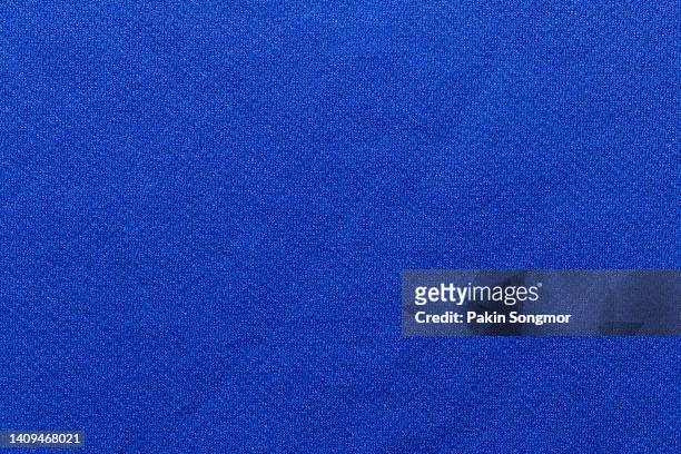 blue color sports clothing fabric football shirt jersey texture and textile background. - jersey stock-fotos und bilder