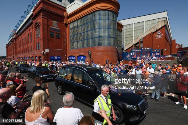 Fans gather at Ibrox Stadium as the funeral cortege of one of Rangers' greatest ever goalkeeper Andy Goram passes the stadium on July 18, 2022 in...