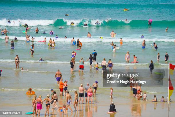 Sunbathers take to the sea at Fistral Beach on July 18, 2022 in Newquay, Cornwall, England. Temperatures were expected to hit 40C in parts of the UK...