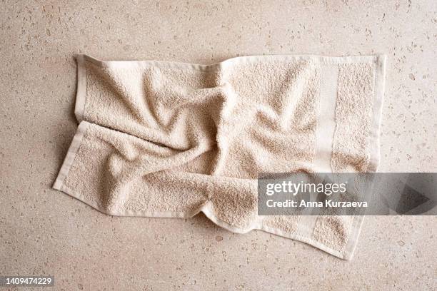 close-up of folded bath towel on concrete background, top view - bath towels stock-fotos und bilder
