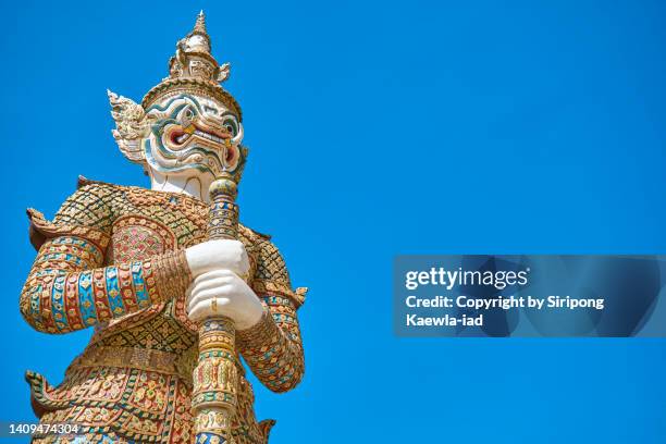 low angle view of guardian name sahatsadecha  inside the wat phra kaew, bangkok. - mace weapon stock pictures, royalty-free photos & images