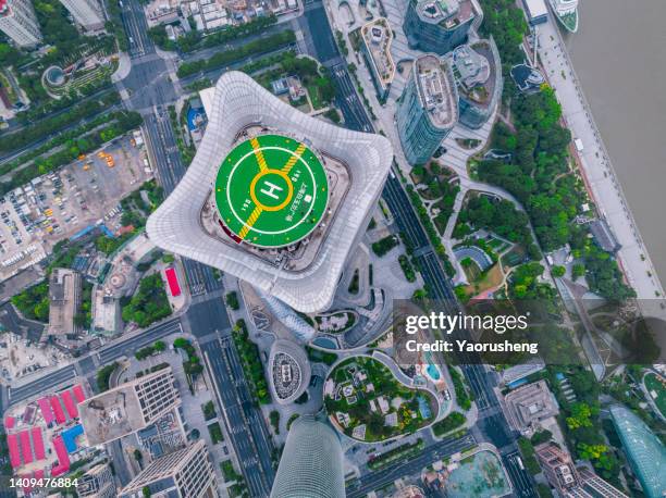 heliplad on the rooftop of a skyscraper  at shanghai city,close to the huangpu river - helipad stock pictures, royalty-free photos & images