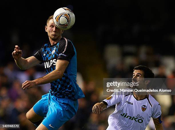 David Albelda of Valencia competes for the ball with Tim Matavz of PSV Eindhoven during the UEFA Europa League Round of 16 first leg match between...