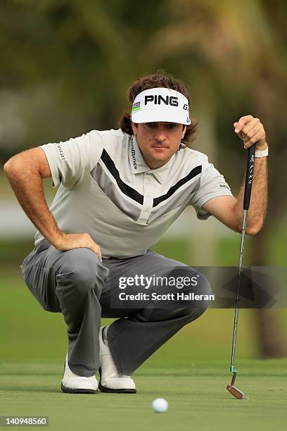 Bubba Watson lines up a putt on the 14th hole during first round of the World Golf Championships-Cadillac Championship on the TPC Blue Monster at...