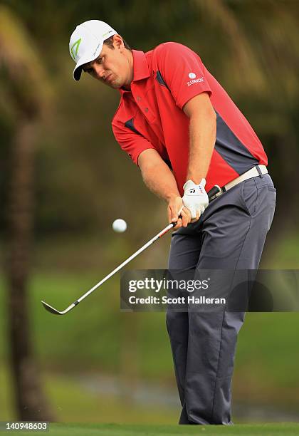 Justin Rose of England plays a shot on the 14th hole during first round of the World Golf Championships-Cadillac Championship on the TPC Blue Monster...