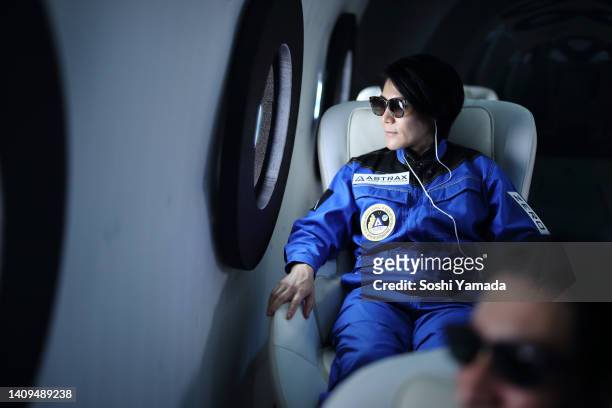 a commercial space traveler looking at the earth through window of the spaceship. - space tourism stock pictures, royalty-free photos & images