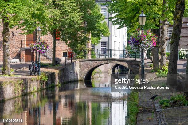calm canal in the old town of amersfoort, holland. - amersfoort nederland stockfoto's en -beelden