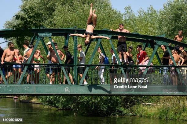 Woman leaps into the River Cam as the temperatures rise on July 18, 2022 in Cambridge, England. Temperatures were expected to hit 40C in parts of the...