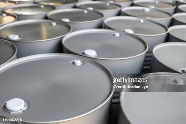 new silver colored oil barrels background - drum container stock-fotos und bilder