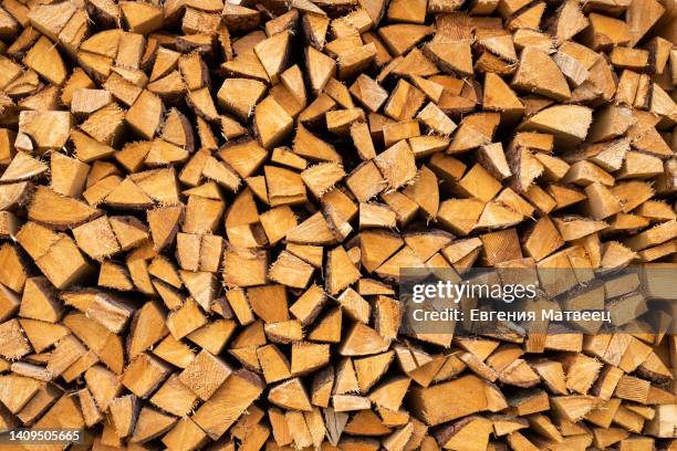 chopped dry firewood wooden logs stacked for winter fireplace. woodpile storage stacks seamless. - chopping stock pictures, royalty-free photos & images