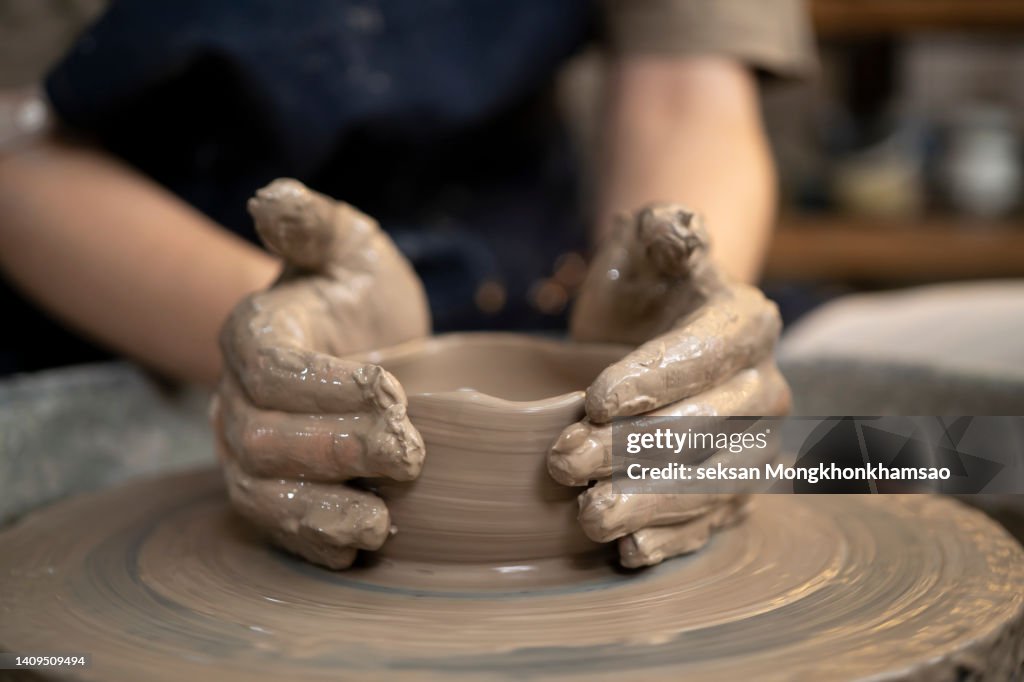 Close up of female potters hands making bowl