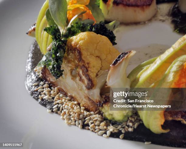 La Urbana in San Francisco features an entree, Cast Iron Scallop with cauliflower, sesame seeds, squash blossoms and kale, which features a Mexican...