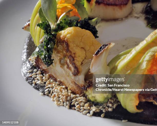 La Urbana in San Francisco features an entree, Cast Iron Scallop with cauliflower, sesame seeds, squash blossoms and kale, which features a Mexican...