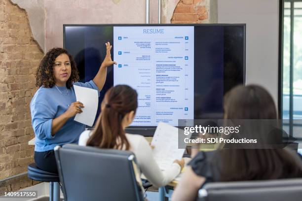 mid adult human resources representative leads a resume building class - cv bildbanksfoton och bilder