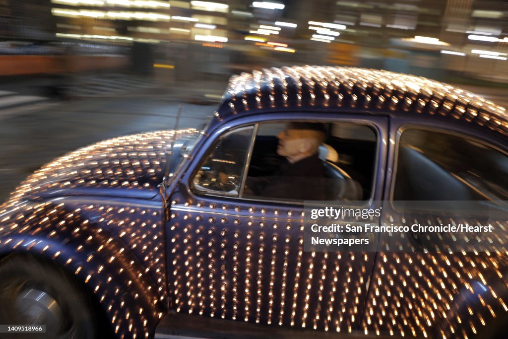 Eric Staller drives by in his illuminated Volkswagen Beetle in San Francisco, Calif., on Wednesday, November 3, 2014, as part of Illuminate SF. Illuminate SF is a series of free holiday art tours to light installations around the city that include ""Firef