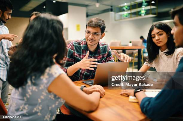 group of young people discussing in the co-working office - new business foto e immagini stock