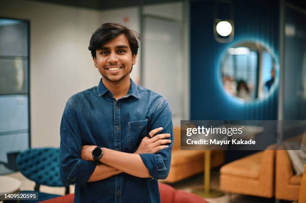 portrait of a young man in the co-working office - india office stock pictures, royalty-free photos & images