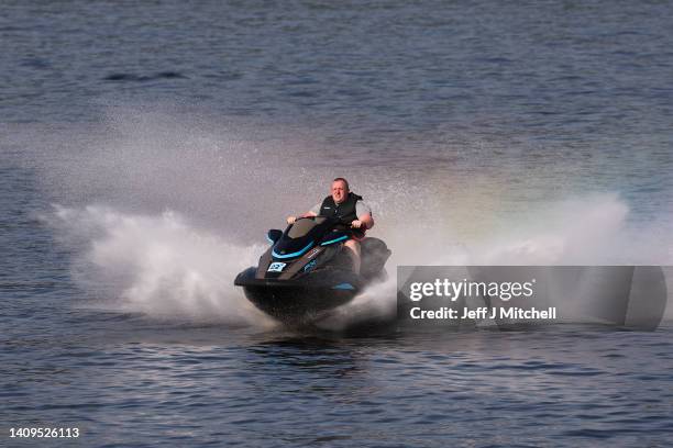 Members of the public cool off by jet skiing at Loch Lomond on July 18, 2022 in Luss, Scotland. The Met Office has warned that temperatures could...