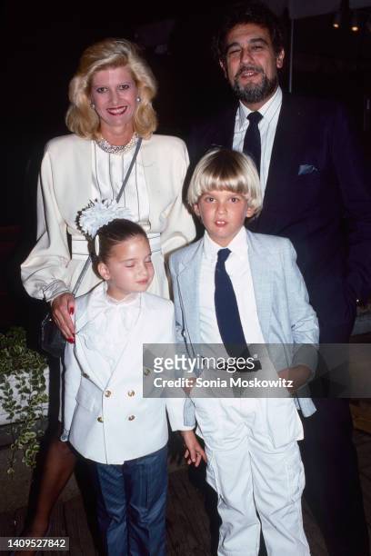 Ivana Trump poses with opera singer Placido Domingo and her children Ivanka Trump and Eric Trump at an event in New York City in October 1987.