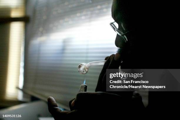 Isaac"" puts a lighter on the pipe he uses to smoke his crystal methamphetamine as he smokes a small amount in his apartment on Monday, April 21,...