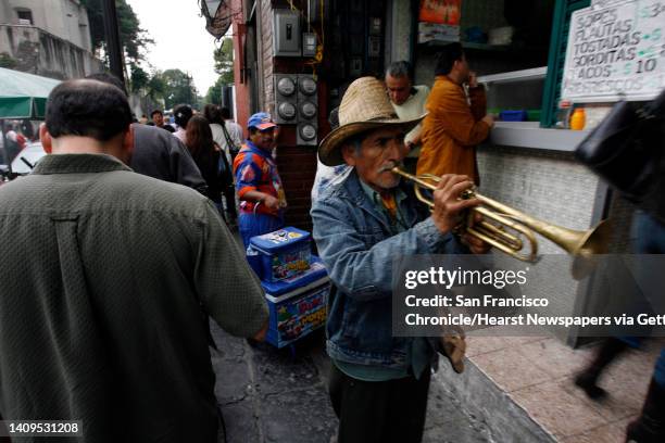 Street musicians and vendors walk the streets in Coyocan neighborhood of Mexico City on Saturday, November 11, 2006. For many mexicans low paying...