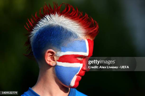 An Iceland fan wears face paint as they show their support prior to the UEFA Women's Euro 2022 group D match between Iceland and France at The New...