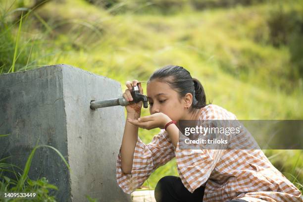 rural girl drinking tap water - drinking water shortage stock pictures, royalty-free photos & images
