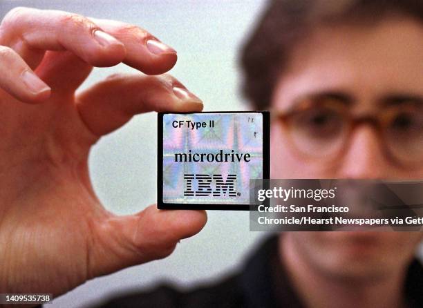 S Scott Arenson holds one of the company's newest items being produced at the San Jose disk drive facility, a 340-megabyte Microdrive which has...