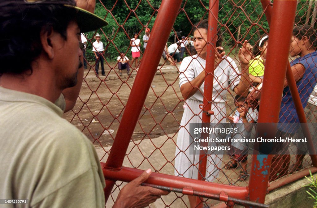 NICARAG-03/C/12NOV98/MN/CG --- Citizens of Posoltega, Nicaragua, line up outside the municipal center hoping to recieve aid from local and national leaders inside, as food and water are in short supply with local bridges and roads having been destroyed by