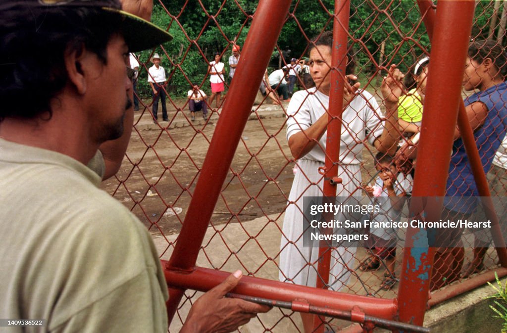 NICARAG-03/C/12NOV98/MN/CG --- Citizens of Posoltega, Nicaragua, line up outside the municipal center hoping to recieve aid from local and national leaders inside, as food and water are in short supply with local bridges and roads having been destroyed by