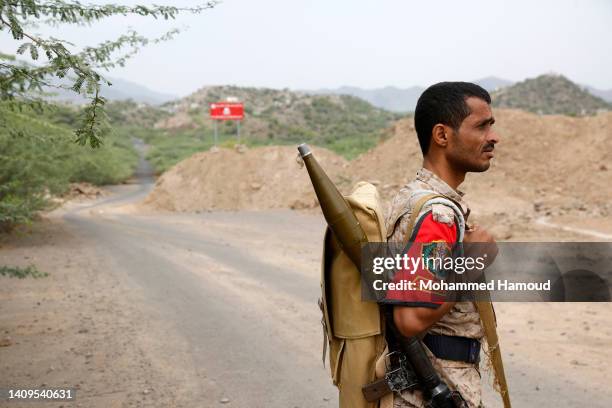 Fighter of the Houthi group stands while patrolling at AL-Khamseen closed street, which leads to the center of Taiz city amid a continuing...